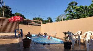 a group of people in a swimming pool at Casa em Alter do chão com piscina in Santarém