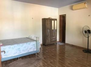 a bedroom with a bed and a fan in it at Casa em Alter do chão com piscina in Santarém