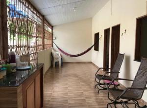 a hallway with chairs and a hammock in a room at Casa em Alter do chão com piscina in Santarém
