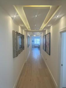 a hallway with paintings on the walls of a building at Hestia Travel Mayfair London in London