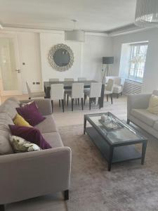 a living room with a couch and a table at Hestia Travel Mayfair London in London