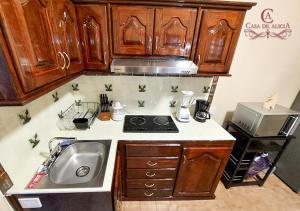 a kitchen with a sink and a stove at Casa de Alicia Departamento Yagul in Oaxaca City +27 photos