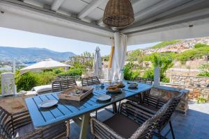 a blue table and chairs on a patio at Panorama Maisonette in Livadia