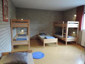 A bed or beds in a room at Hostel Blauwput Leuven