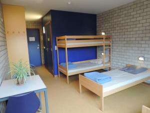 A bed or beds in a room at Hostel Blauwput Leuven