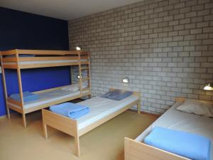 A bed or beds in a room at Hostel Blauwput Leuven