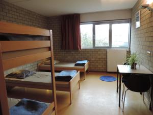 A bed or beds in a room at Hostel Blauwput Leuven