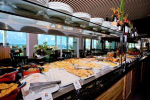 a buffet table with many different types of food at Monte Pascoal Praia Hotel Salvador in Salvador