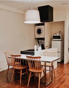 a kitchen with a table and chairs in a kitchen at Blue Steak Wonder Chatan in Chatan