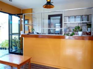 a bar in a room with a table and a bench at Golden Pension House,Palawan in Puerto Princesa City