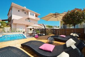a patio with a swimming pool and a building at Apartments Villa Golden View in Trogir