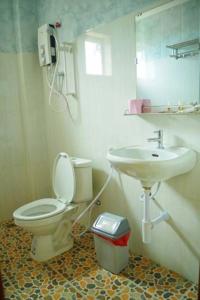 a bathroom with a toilet and a sink at Golden Star Inn in Sihanoukville