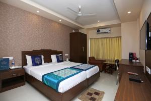 a bedroom with a bed and a desk and a television at HOTEL RAILVIEW Bhubaneswar in Bhubaneshwar