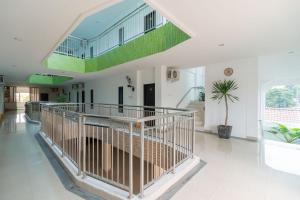 a large room with a staircase and a large window at Urbanview Hotel Ephe Palembang in Palembang