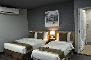 Katil atau katil-katil dalam bilik di Valya Hotel, Kuala Terengganu
