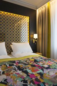 a bedroom with a bed with a patterned headboard at Thon Hotel Rosenkrantz Oslo in Oslo