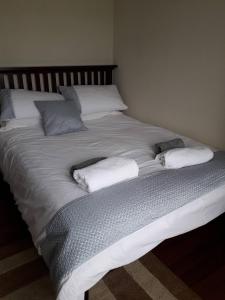 a large white bed with two pillows on it at Room in Apartment - 1 Bedroom In A Homely Home With A Lovely Farm 