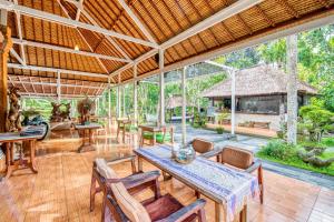 an outdoor living room with a table and chairs at Ubud Sari Health Resort in Ubud