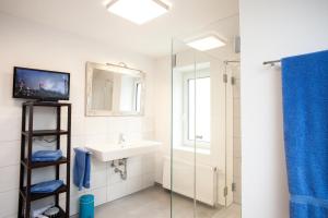 a bathroom with a sink and a mirror at P&G Rooms in Höhr-Grenzhausen