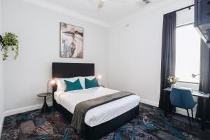 A bed or beds in a room at Royal Hotel Wyong