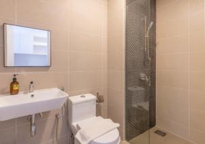 a bathroom with a toilet and a sink and a shower at Greystone Continew Residensi in Kuala Lumpur