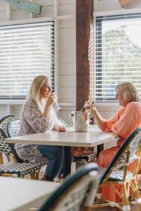 two women sitting at a table in a restaurant at Royal Hotel Wyong in Wyong