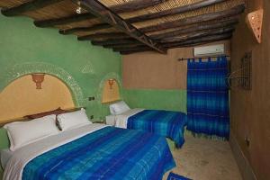 Postel nebo postele na pokoji v ubytování Palmeras Y Dunas Luxery Camp
