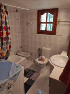 a bathroom with a toilet and a sink at Kotrwnas Family Traditional Villa Seaview in Kótronas