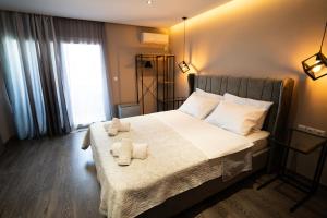 a bedroom with a bed with towels on it at Parthenis Riviera Hotel in Athens