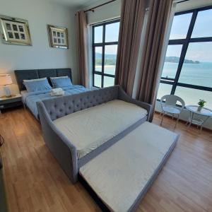 a bedroom with a bed and a large window at Kuantan Imperium seaview cityview by Avenzee in Kuantan