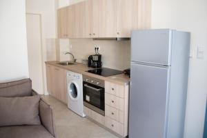 uma cozinha com um frigorífico e uma máquina de lavar roupa em Naxian Place em Agios Prokopios