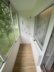 a hallway of a house with a window at Modern 2 Room Apartment - FREE PARKING - NETFLIX in Alytus