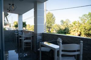 a row of tables and chairs on a balcony at Parthenis Riviera Hotel in Athens