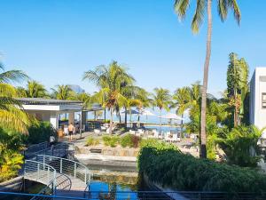 a view of a resort with a pool and palm trees at Latitude - with private plunge pool in Rivière Noire