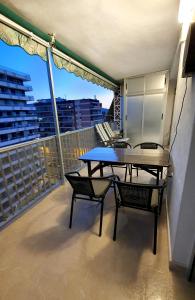 a balcony with a table and chairs on a roof at Piso familiar con amplia terraza 300m de la playa in Cullera