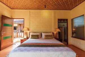 Postel nebo postele na pokoji v ubytování Munari Resort Ubud