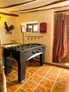 a ping pong table in a living room with at Calle Horno in Castril