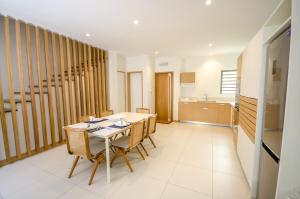 a kitchen and dining room with a table and chairs at Latitude - with private plunge pool in Rivière Noire