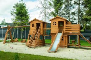 a playground with a slide and a play house at Apartamenty pod Zamkiem in Łapalice