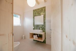 a bathroom with a sink and a mirror at Garnì Aurora Bed and Breakfast in Soraga