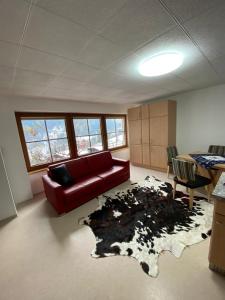 a living room with a couch and a cow rug at Reiter, Haus in Finkenberg