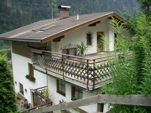 a house with a balcony on the side of it at Reiter, Haus in Finkenberg