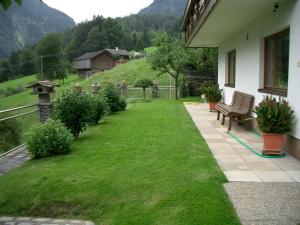 a yard with a bench on a house at Reiter, Haus in Finkenberg +8 photos