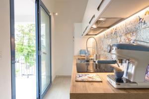 a kitchen with a mixer sitting on a counter at Casa Vacanze il mirto in Bari Sardo