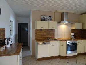 a kitchen with white cabinets and a stove top oven at Bei Schütts in Janneby