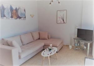 a living room with a couch and a table at Anthoula house in Vlachopoulátika