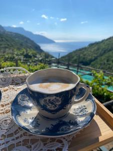 a blue and white cup of coffee sitting on a table at Villa Costanza sorrento B&b in Sant'Agnello