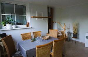 a dining room with a table and chairs with candles on it at Relaxoase ***** in Krakow am See