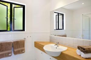 a bathroom with a sink and a mirror at 3 Hilltop Villas White Water Views from the Heart of Sunshine in Sunshine Beach +11 photos