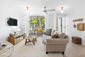 a living room with a couch and a table at 5 Samarin Court Convenient and Comfortable in Sunshine Beach